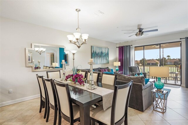 dining room featuring light tile patterned flooring, ceiling fan with notable chandelier, and baseboards