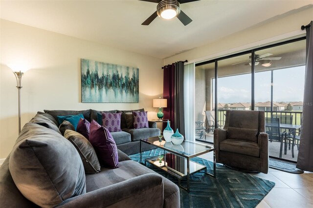living area with tile patterned flooring and a ceiling fan