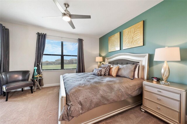 bedroom with baseboards, carpet floors, and a ceiling fan