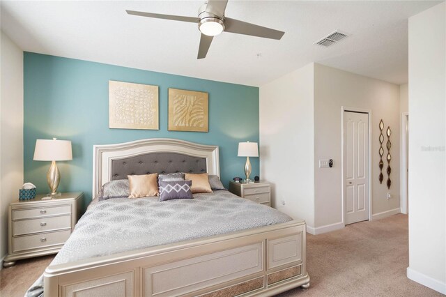 bedroom featuring light carpet, baseboards, visible vents, and ceiling fan