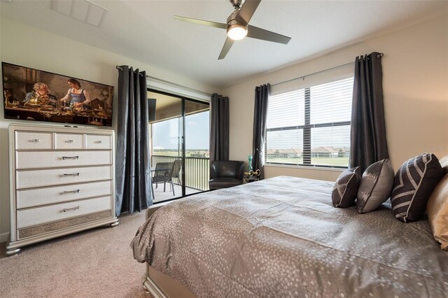 carpeted bedroom featuring multiple windows, a ceiling fan, access to exterior, and visible vents