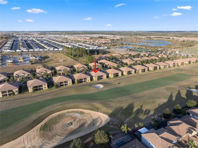 aerial view with a residential view, golf course view, and a water view