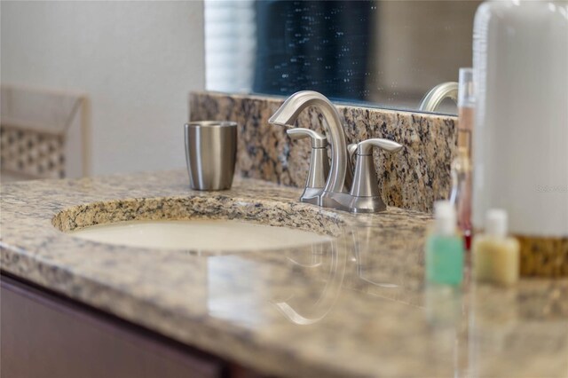 details featuring vanity and backsplash