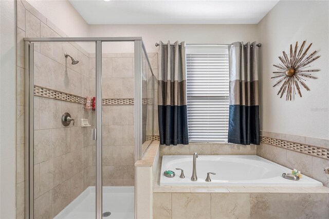 full bathroom featuring a shower stall and a bath