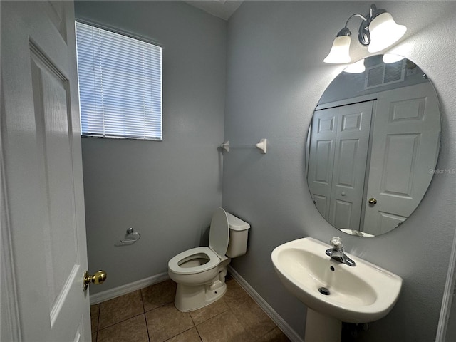 bathroom featuring sink, tile patterned floors, and toilet