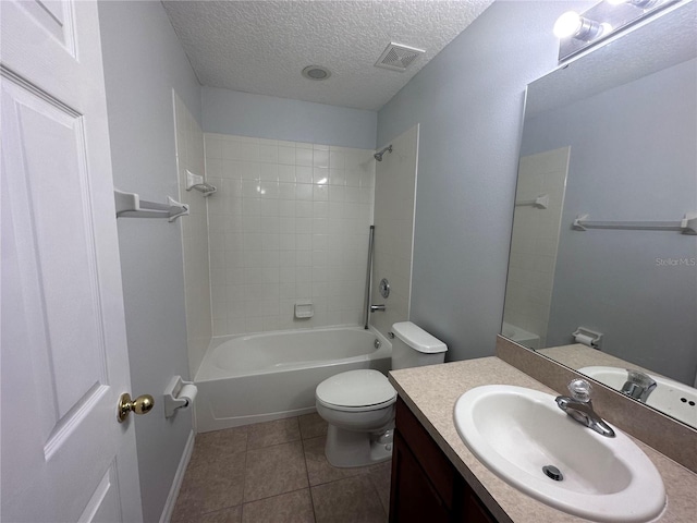 full bathroom with tiled shower / bath, tile patterned flooring, vanity, toilet, and a textured ceiling