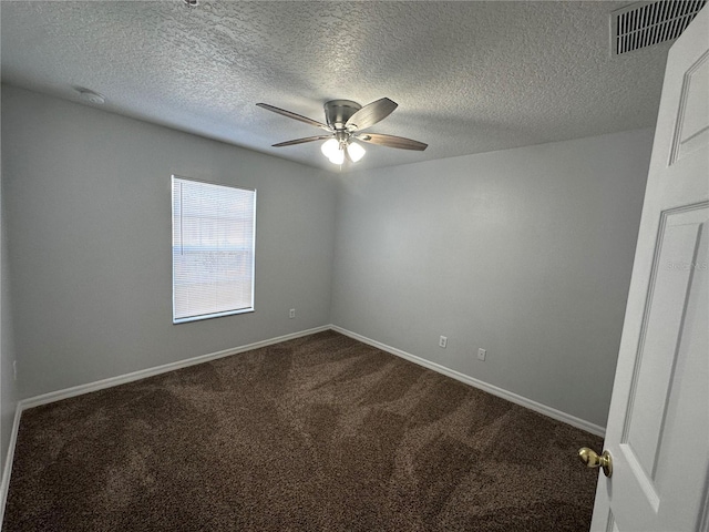 carpeted spare room featuring ceiling fan and a textured ceiling