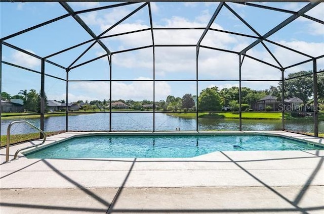 view of pool featuring a water view, a patio area, and glass enclosure