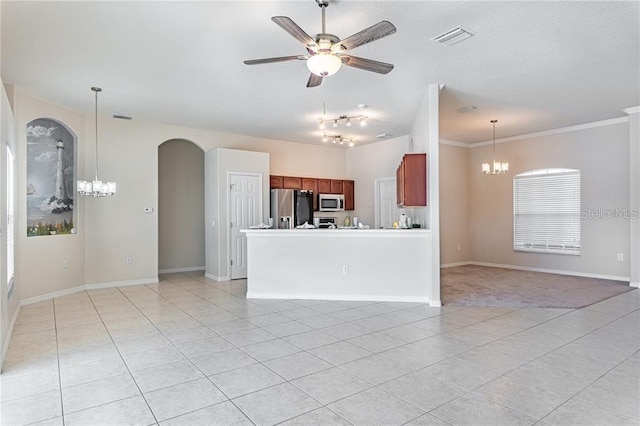 kitchen featuring stainless steel appliances, pendant lighting, ceiling fan with notable chandelier, and light tile patterned floors