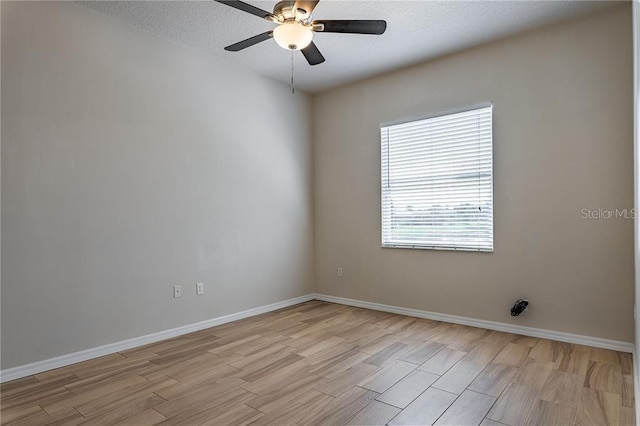 empty room featuring a textured ceiling, light hardwood / wood-style floors, and ceiling fan