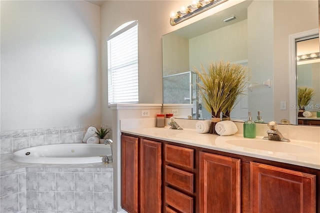 bathroom featuring vanity and shower with separate bathtub