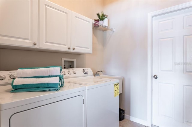 laundry area featuring independent washer and dryer and cabinets