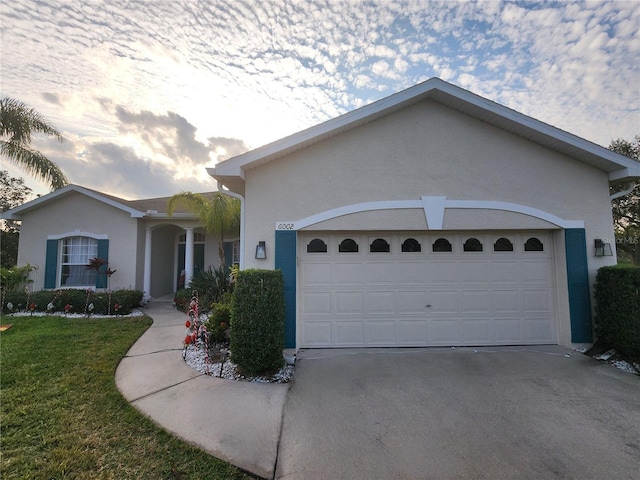 ranch-style house with a garage and a front yard