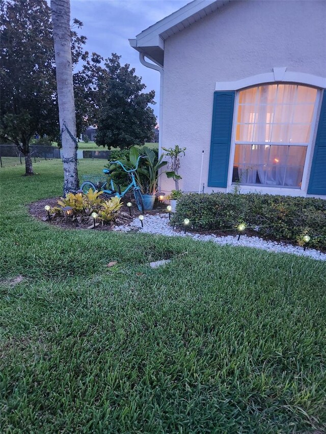 view of side of property with a lawn