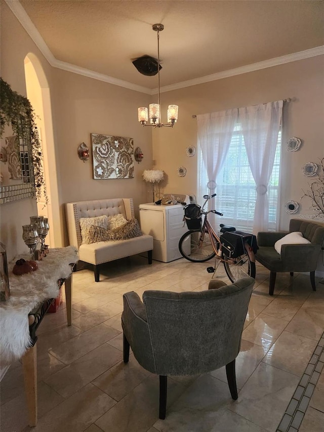 sitting room featuring ornamental molding and a notable chandelier