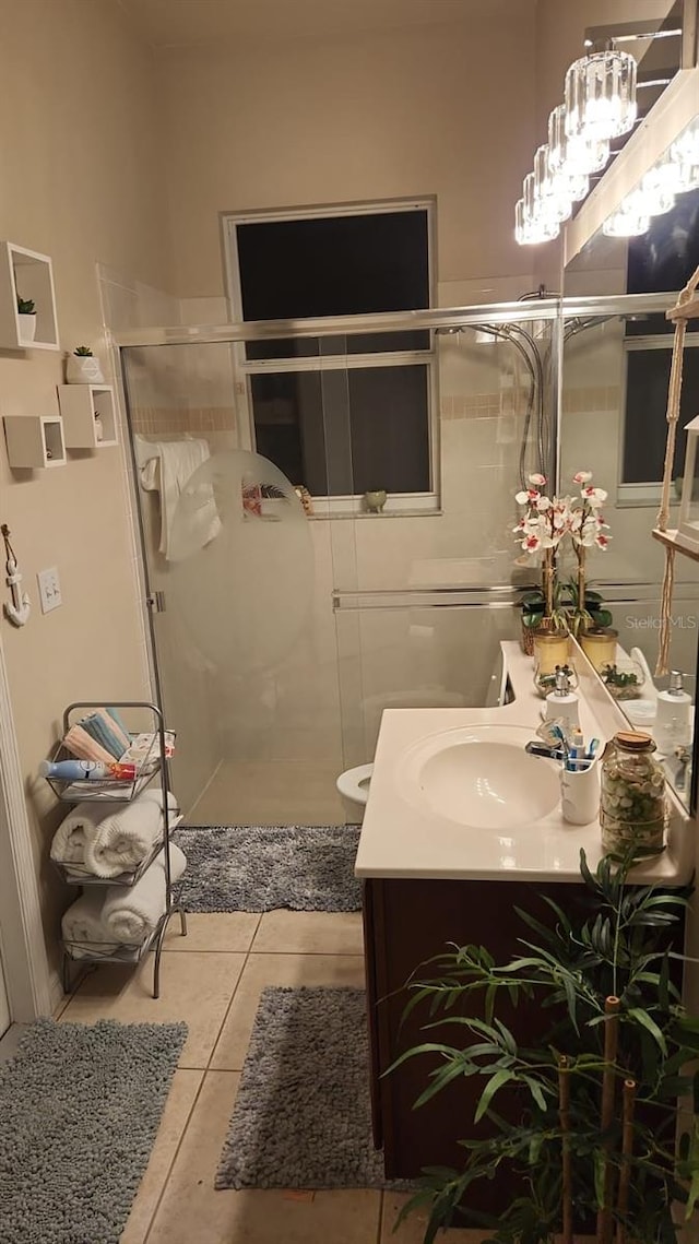 bathroom with vanity, an enclosed shower, and tile patterned floors