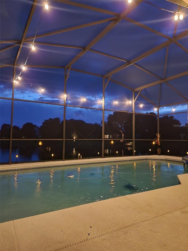 view of swimming pool with glass enclosure