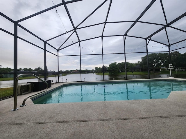 view of pool featuring a water view, a lanai, and a patio