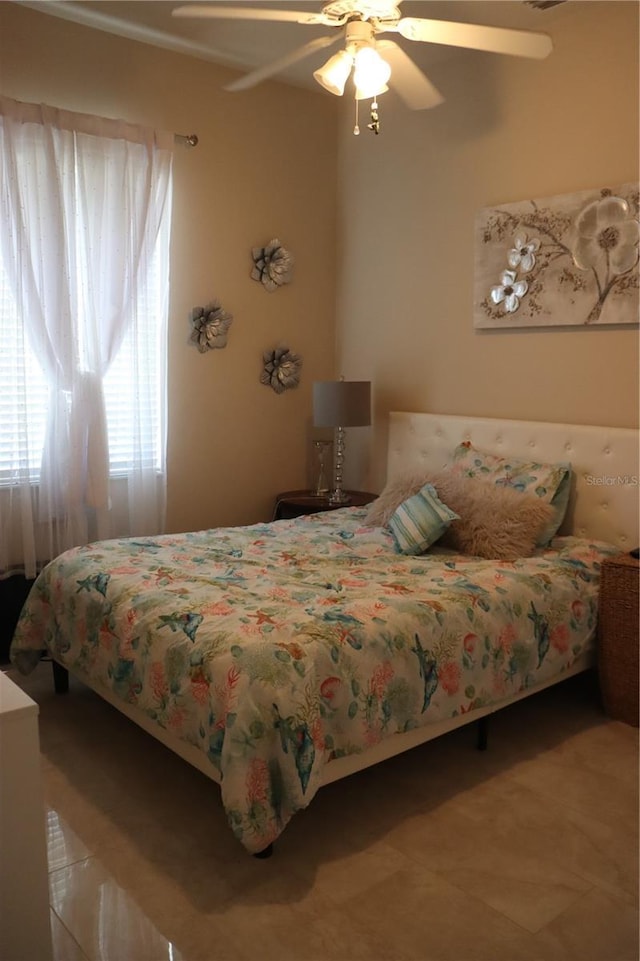 6002 Renaissance Ct, Saint Cloud, FL 34772 - tiled bedroom with a ceiling fan