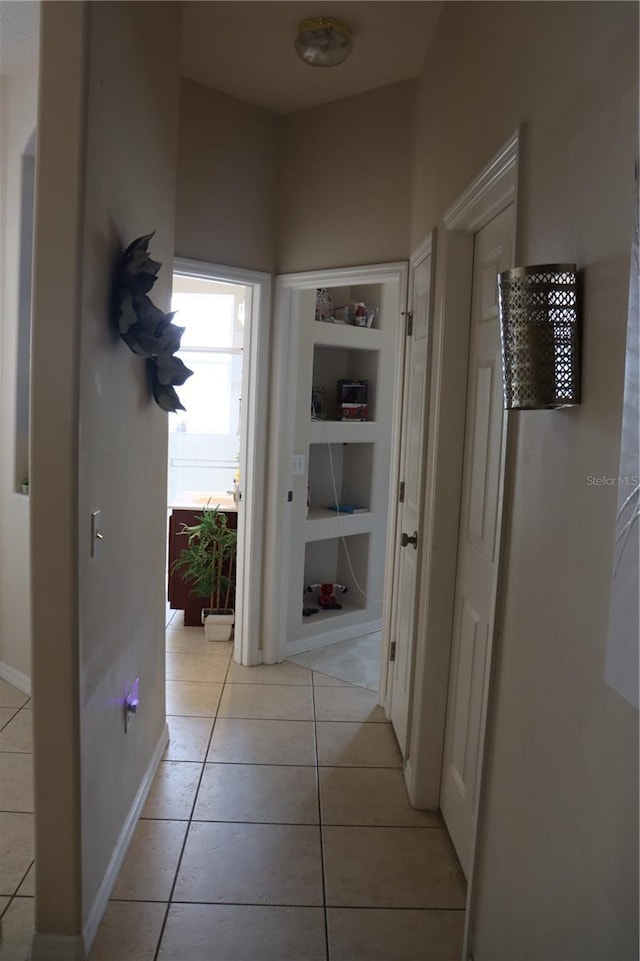 6002 Renaissance Ct, Saint Cloud, FL 34772 - hall featuring light tile patterned flooring and baseboards