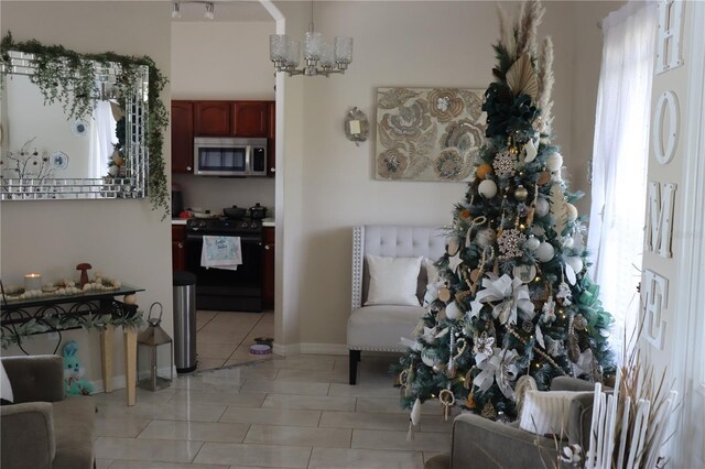 6002 Renaissance Ct, Saint Cloud, FL 34772 - interior space with baseboards, light tile patterned floors, and a notable chandelier