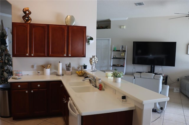 6002 Renaissance Ct, Saint Cloud, FL 34772 - kitchen featuring light tile patterned floors, reddish brown cabinets, white dishwasher, and a sink