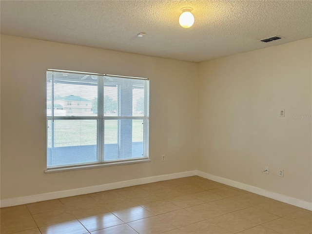 unfurnished room featuring a textured ceiling