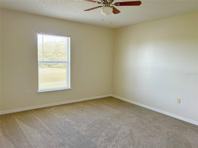 unfurnished room featuring ceiling fan, carpet, and a textured ceiling