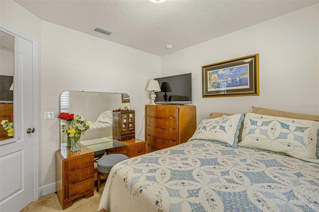 carpeted bedroom with a textured ceiling