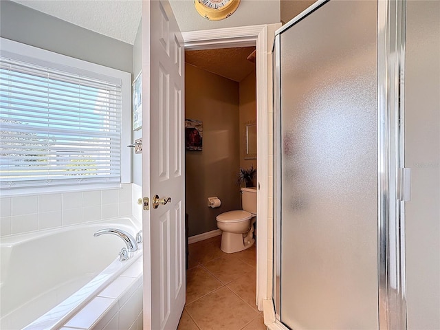 bathroom with separate shower and tub, tile patterned floors, a textured ceiling, and toilet