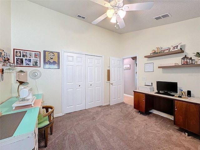 office featuring ceiling fan, carpet flooring, vaulted ceiling, and a textured ceiling