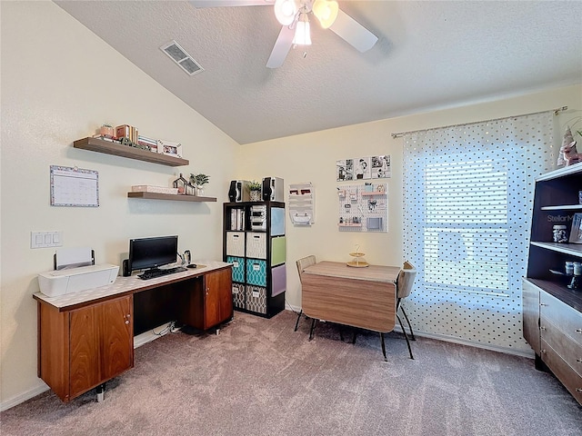 office space with ceiling fan, vaulted ceiling, a textured ceiling, and carpet flooring