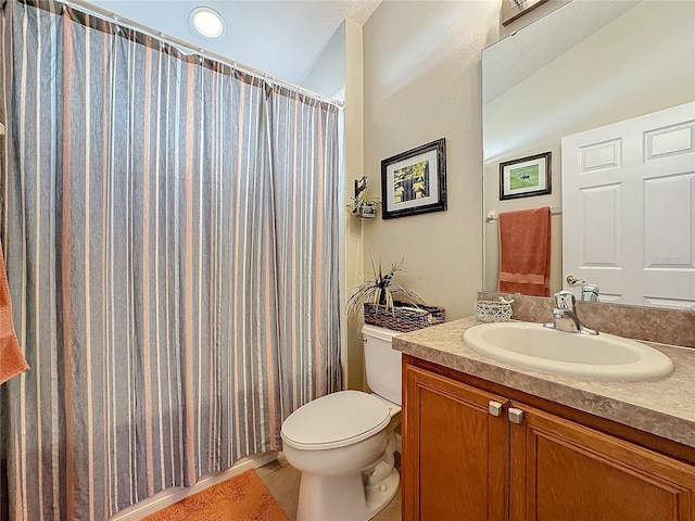 bathroom with walk in shower, tile patterned floors, vanity, and toilet