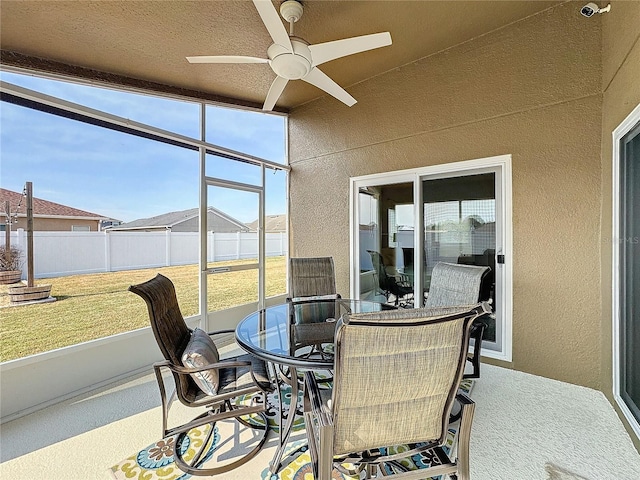 sunroom / solarium featuring ceiling fan