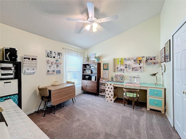 carpeted office space featuring vaulted ceiling, ceiling fan, and a textured ceiling