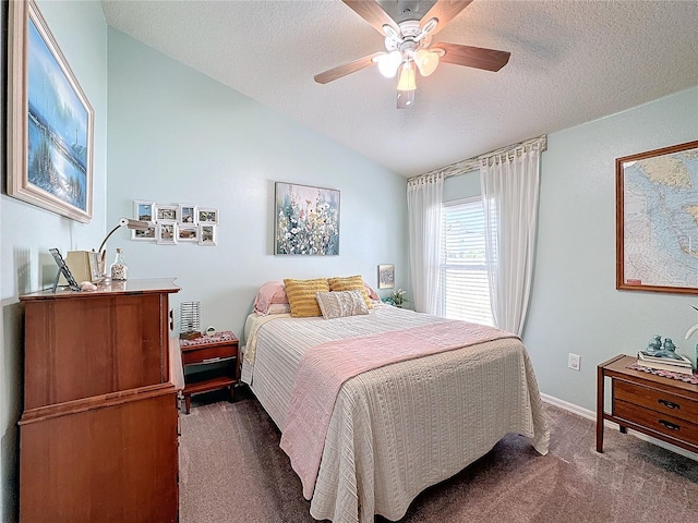 carpeted bedroom featuring lofted ceiling, ceiling fan, a textured ceiling, and baseboards