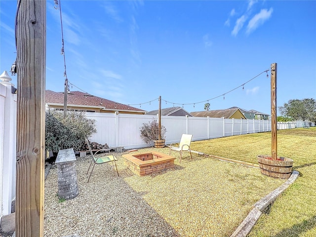 view of yard featuring a fire pit and fence