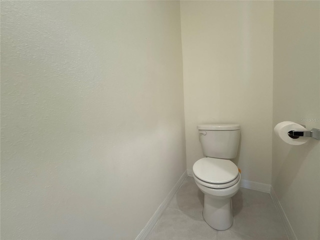 bathroom featuring tile patterned flooring and toilet