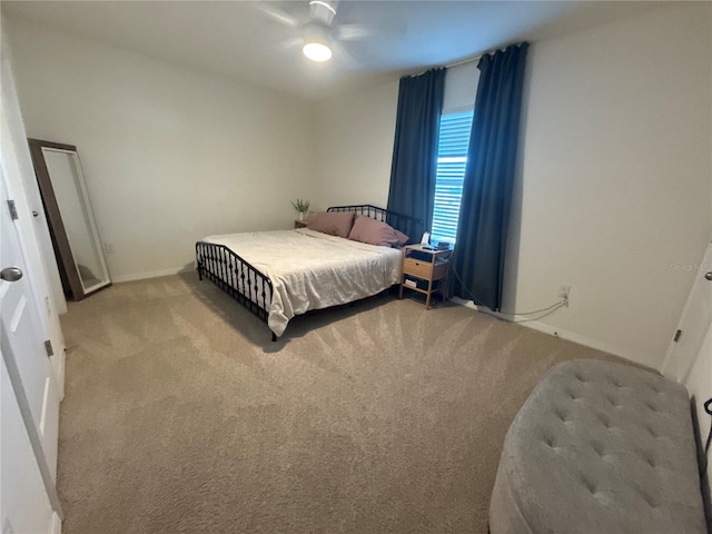 bedroom featuring ceiling fan and light carpet