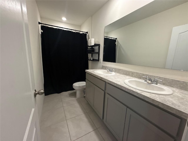 bathroom featuring tile patterned flooring, vanity, and toilet