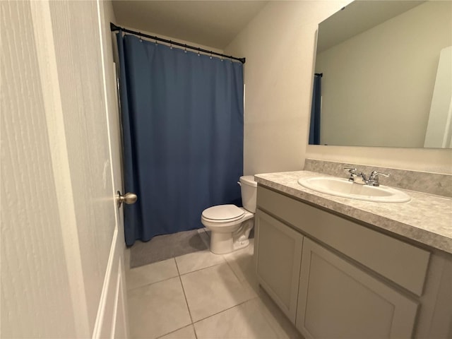 bathroom with vanity, tile patterned floors, and toilet