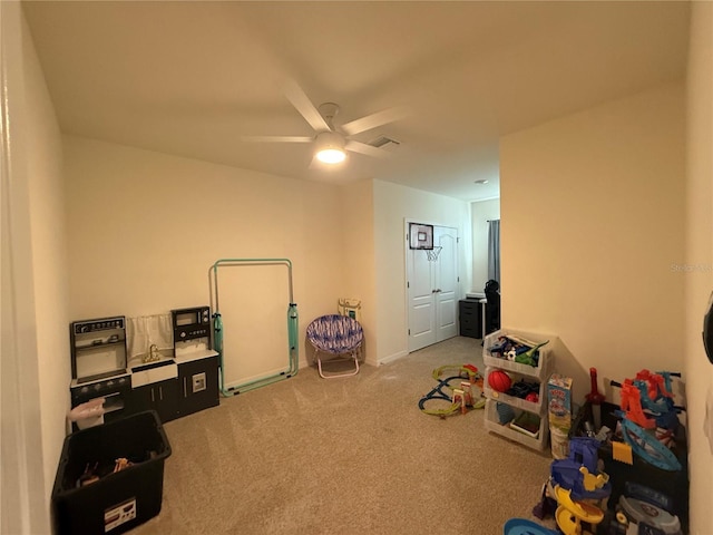 rec room featuring carpet and ceiling fan