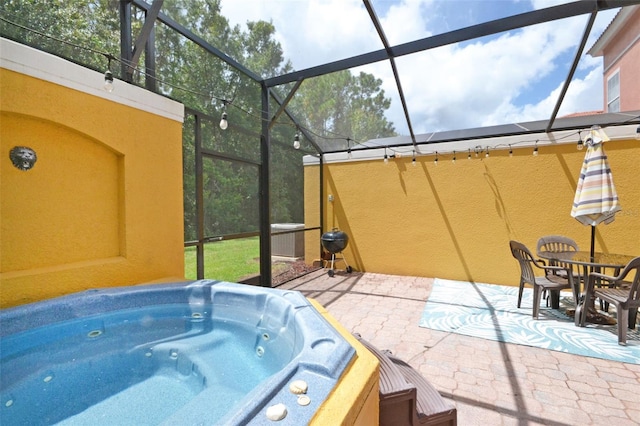 view of patio with a hot tub and a grill