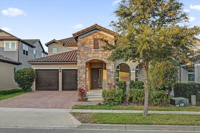 mediterranean / spanish house featuring a garage