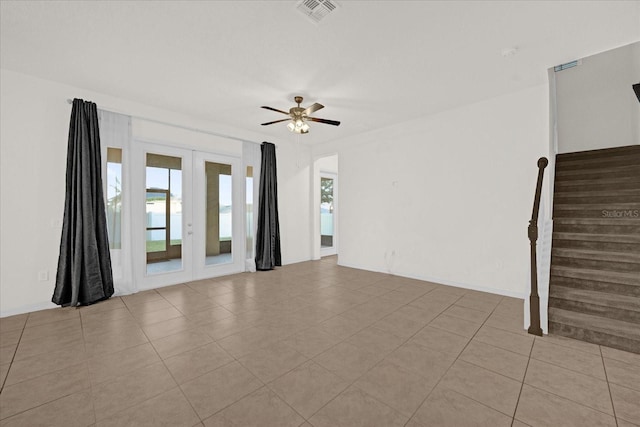 spare room featuring french doors, ceiling fan, and light tile patterned flooring