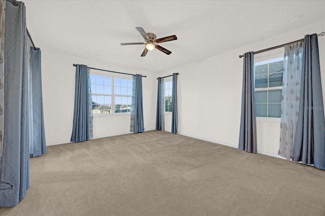 carpeted empty room featuring ceiling fan