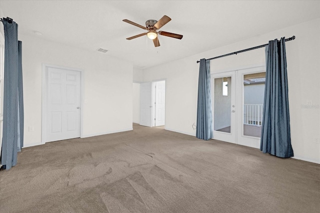 carpeted spare room featuring french doors and ceiling fan