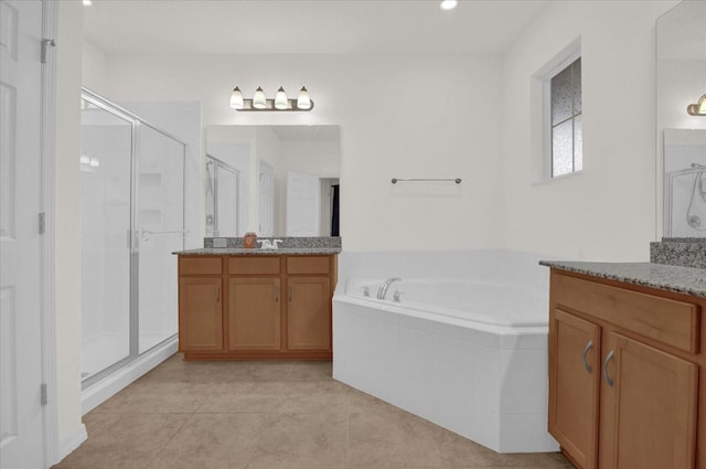 bathroom with tile patterned floors, separate shower and tub, and vanity