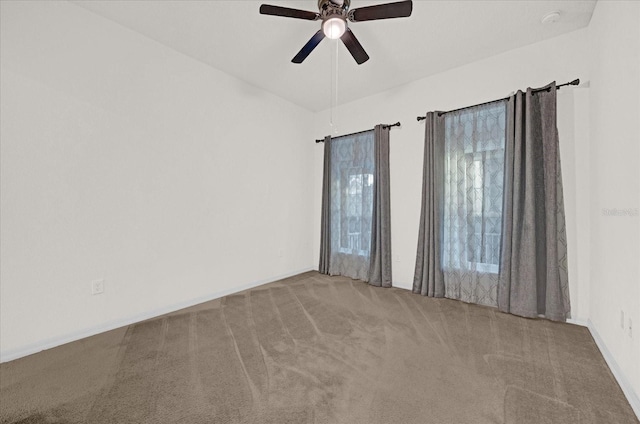 carpeted empty room featuring ceiling fan