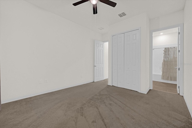 unfurnished bedroom featuring light colored carpet, ceiling fan, and a closet